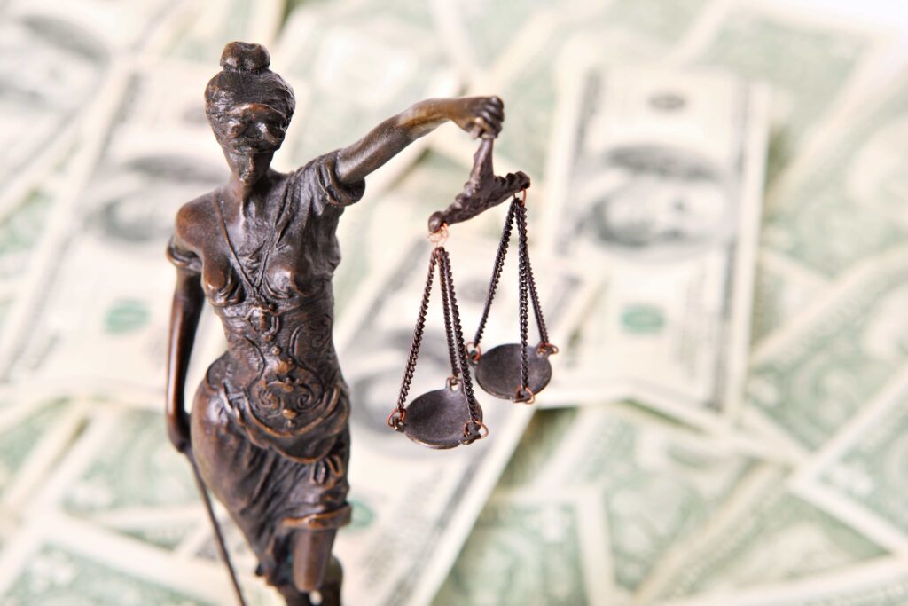 Lady justice with dollar bills in the background